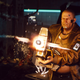 A screenshot from Cyberpunk 2077 depicting a pretty muscular character wielding a heavy machine gun.